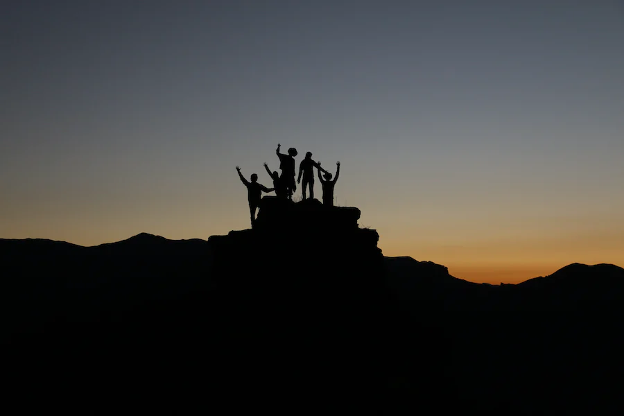team atop a mountain
